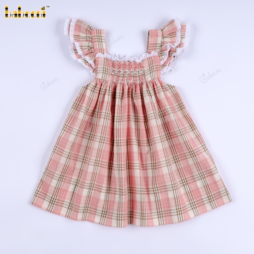 A loose-fitting dress with pleated details in pink and brown checkered pattern.- BB3571